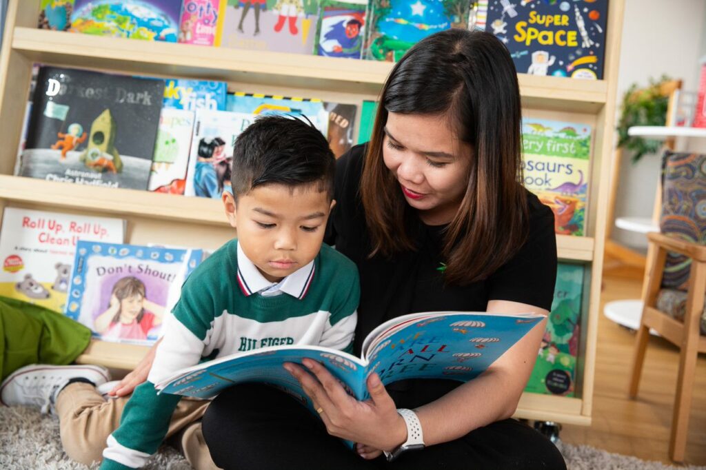 Aspire Boy and Educator Reading Together