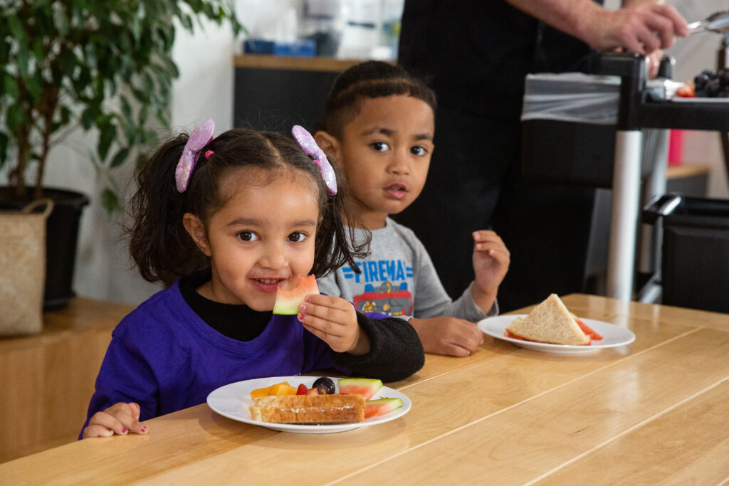 Girl and Boy eating lunch at childcare centre